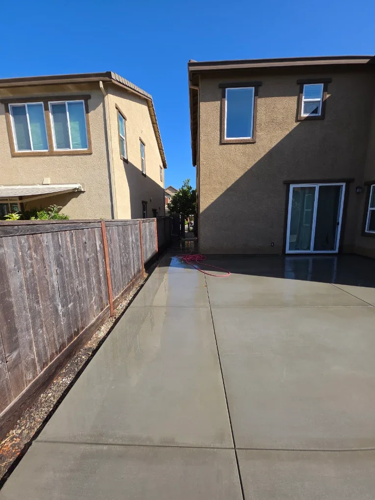 Side-yard concrete path and grass