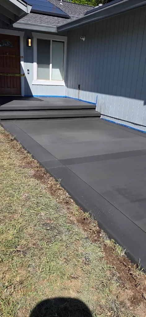Concrete walkway leading toward an entry
