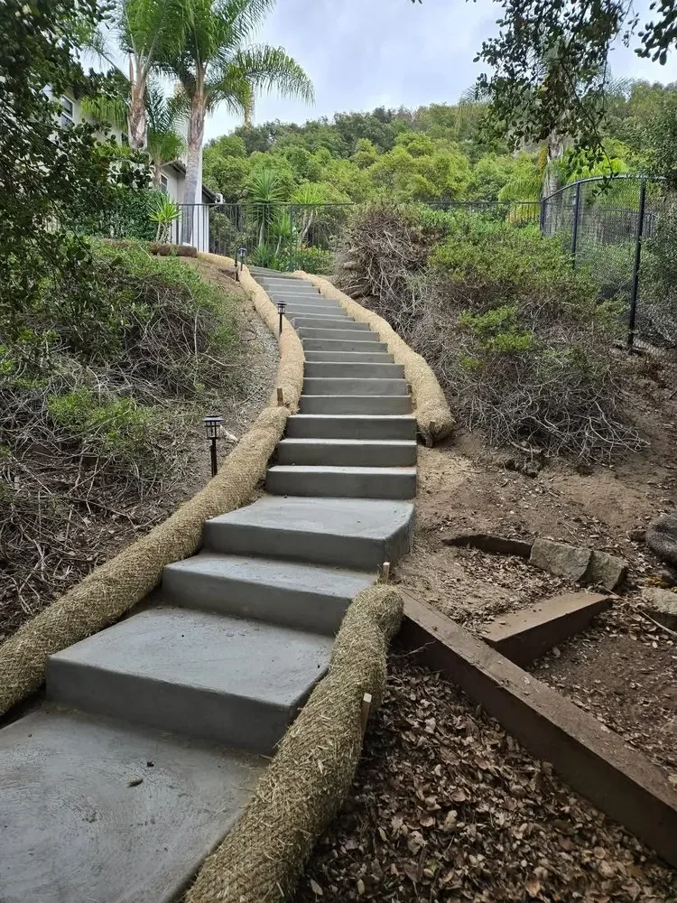 Curved concrete stairs following a landscaped slope