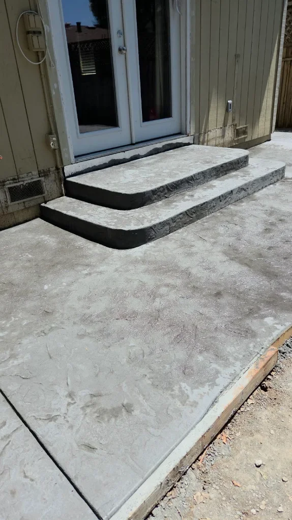 Textured concrete patio and rounded entry steps