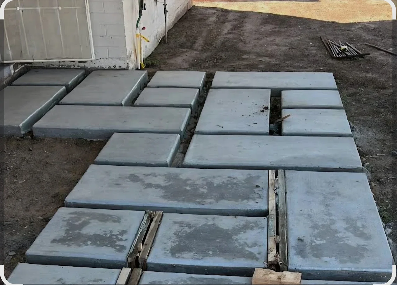 Rectangular concrete pads arranged across a yard