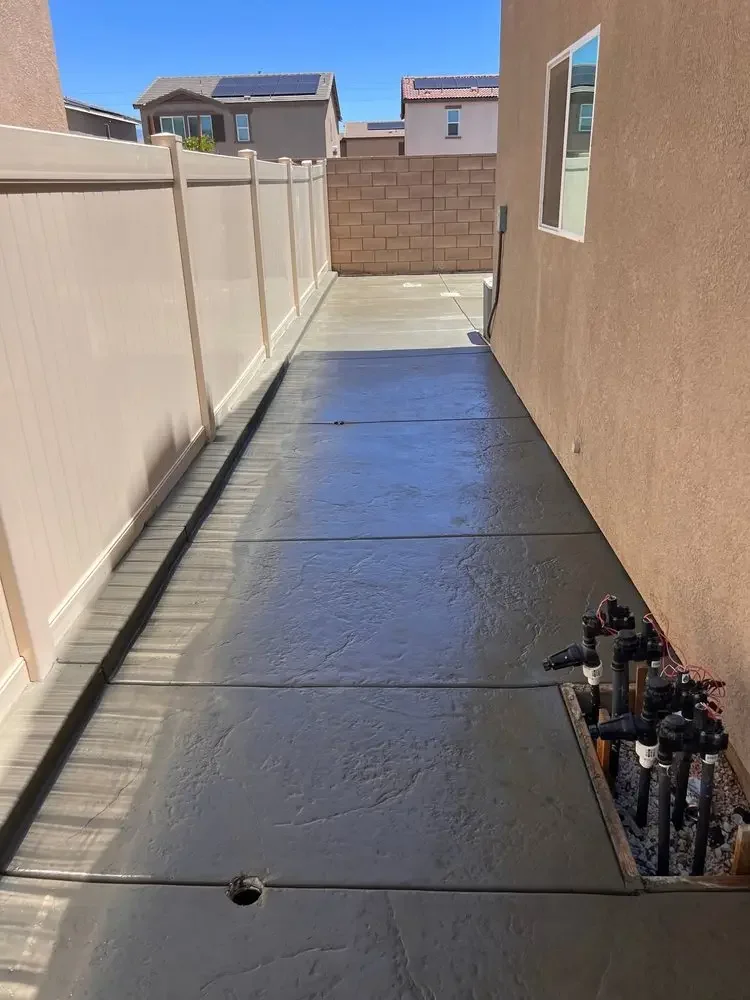 Textured concrete path beside a home