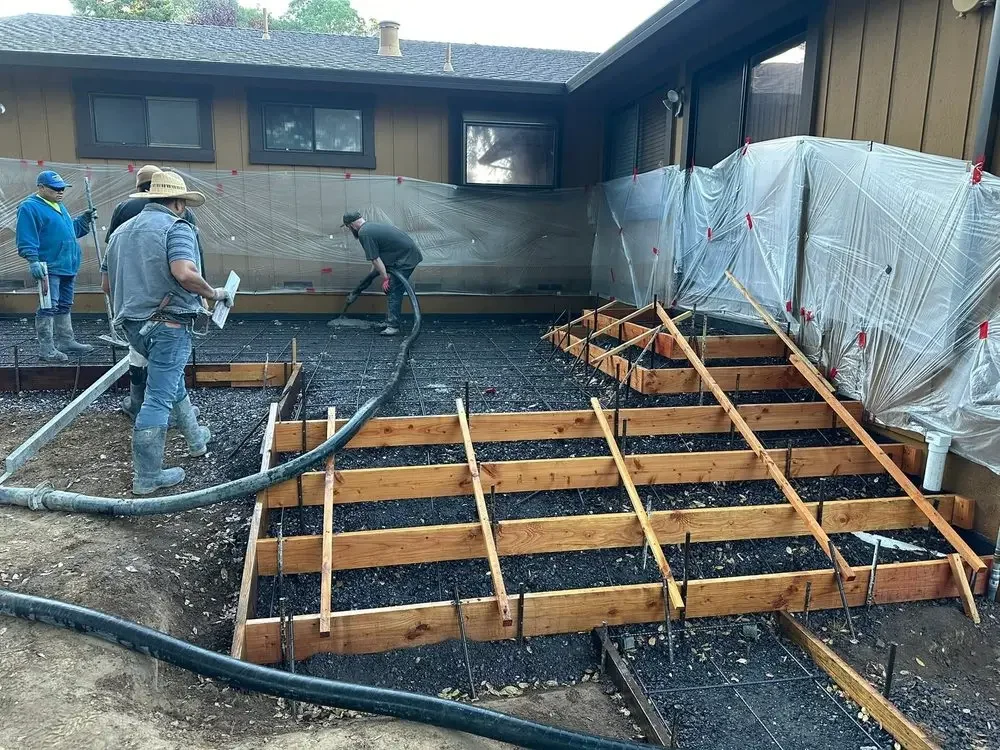 Crew placing concrete inside prepared forms